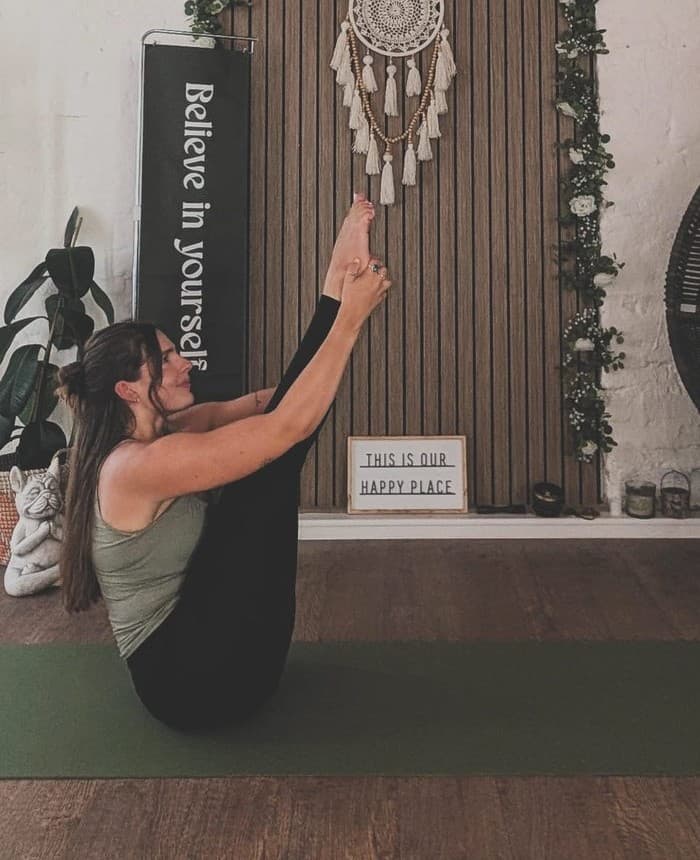 Han on a green mat in the studio at The Art of Wellness